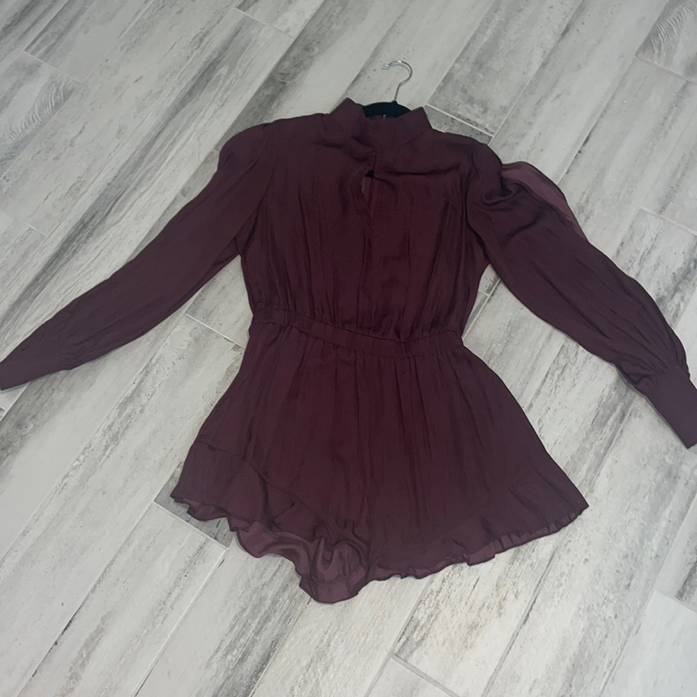 Burgundy romper. Slits on arms.